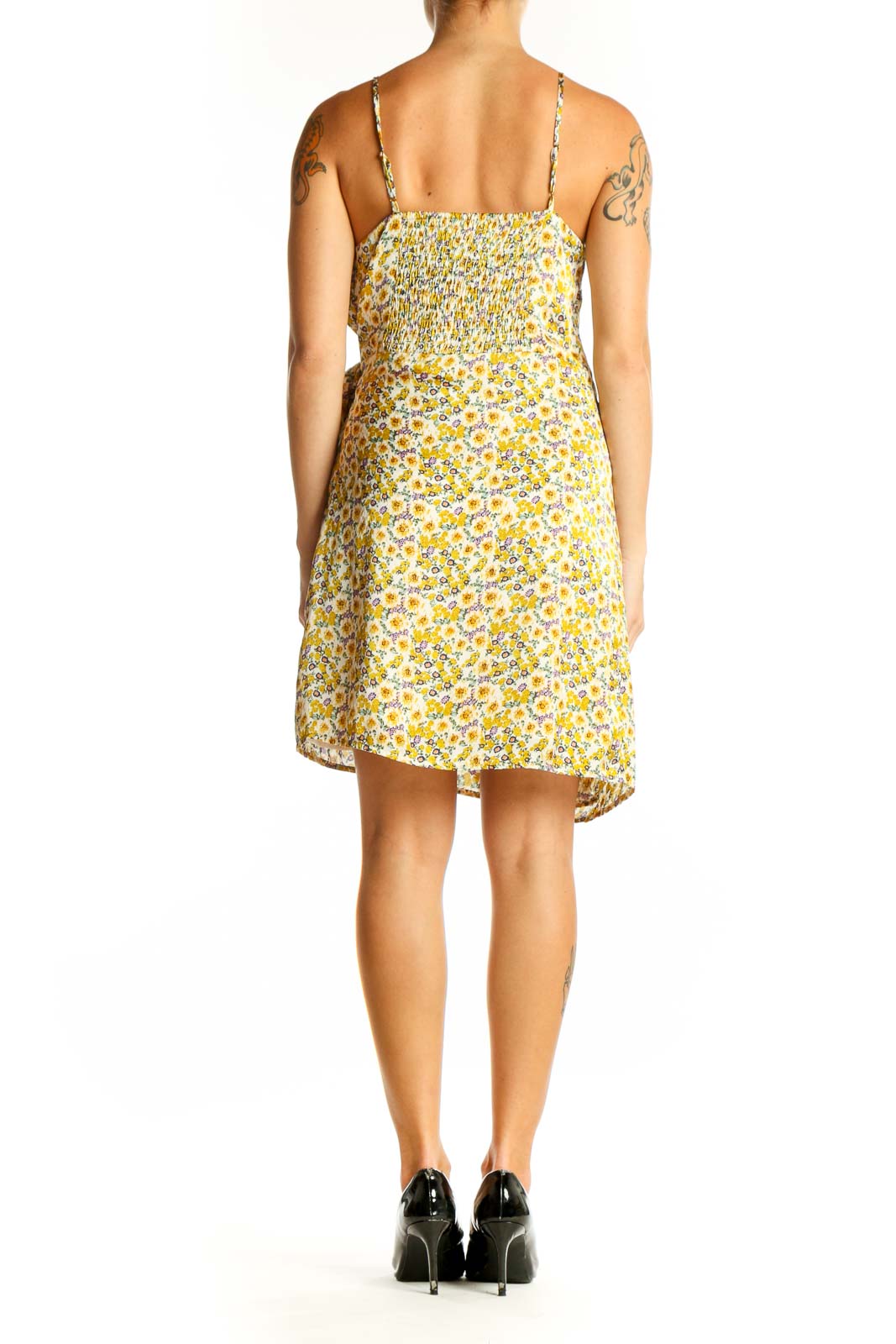 Side view of yellow floral wrap mini dress showing flattering silhouette