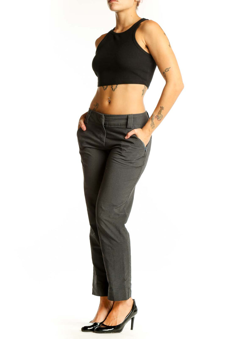 Front view of gray Adidas athletic pants on model