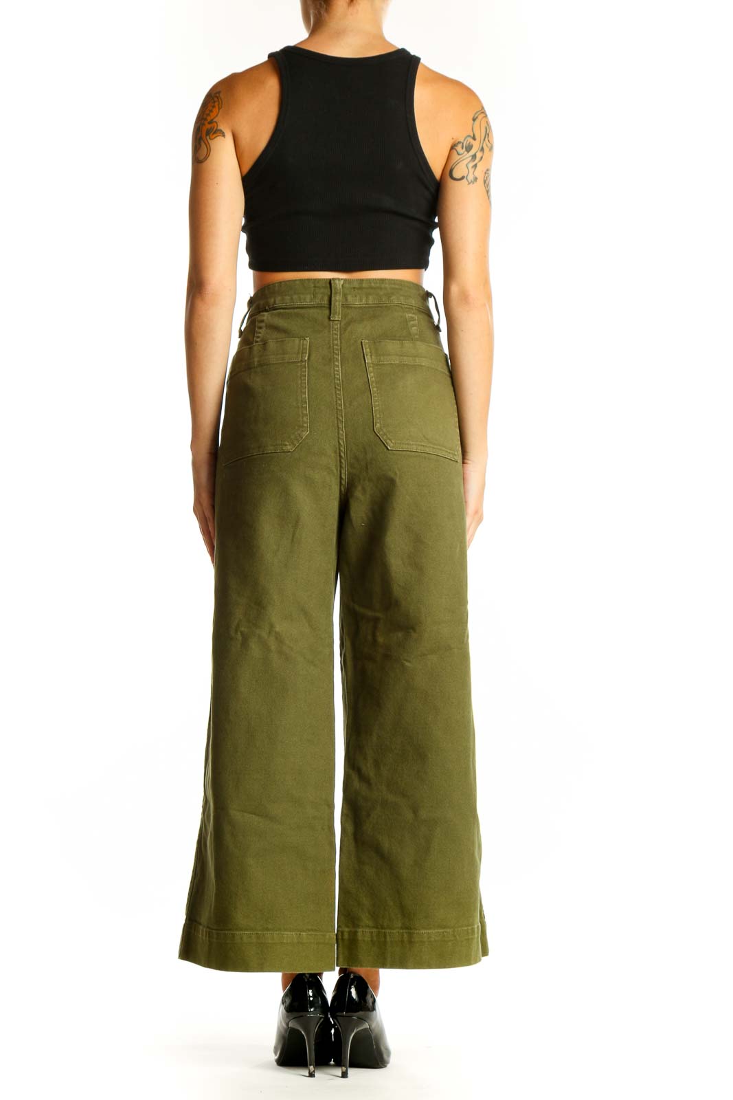Side view of woman wearing olive Madewell wide-leg pants with black top