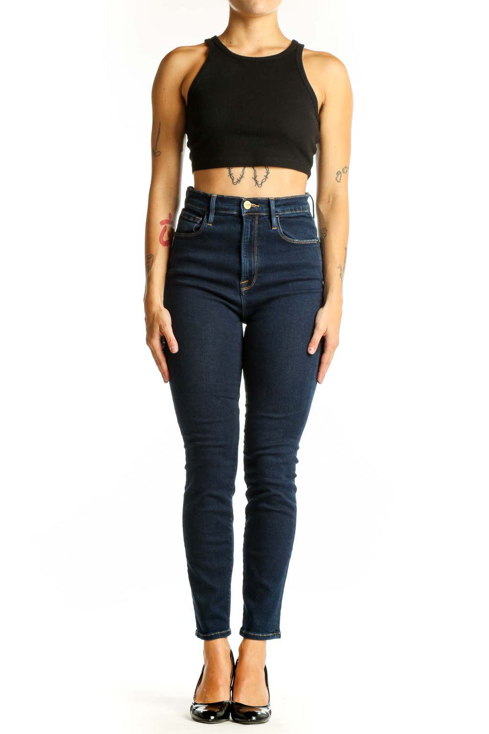 Front view of FRAME dark blue high-waisted skinny jeans on model