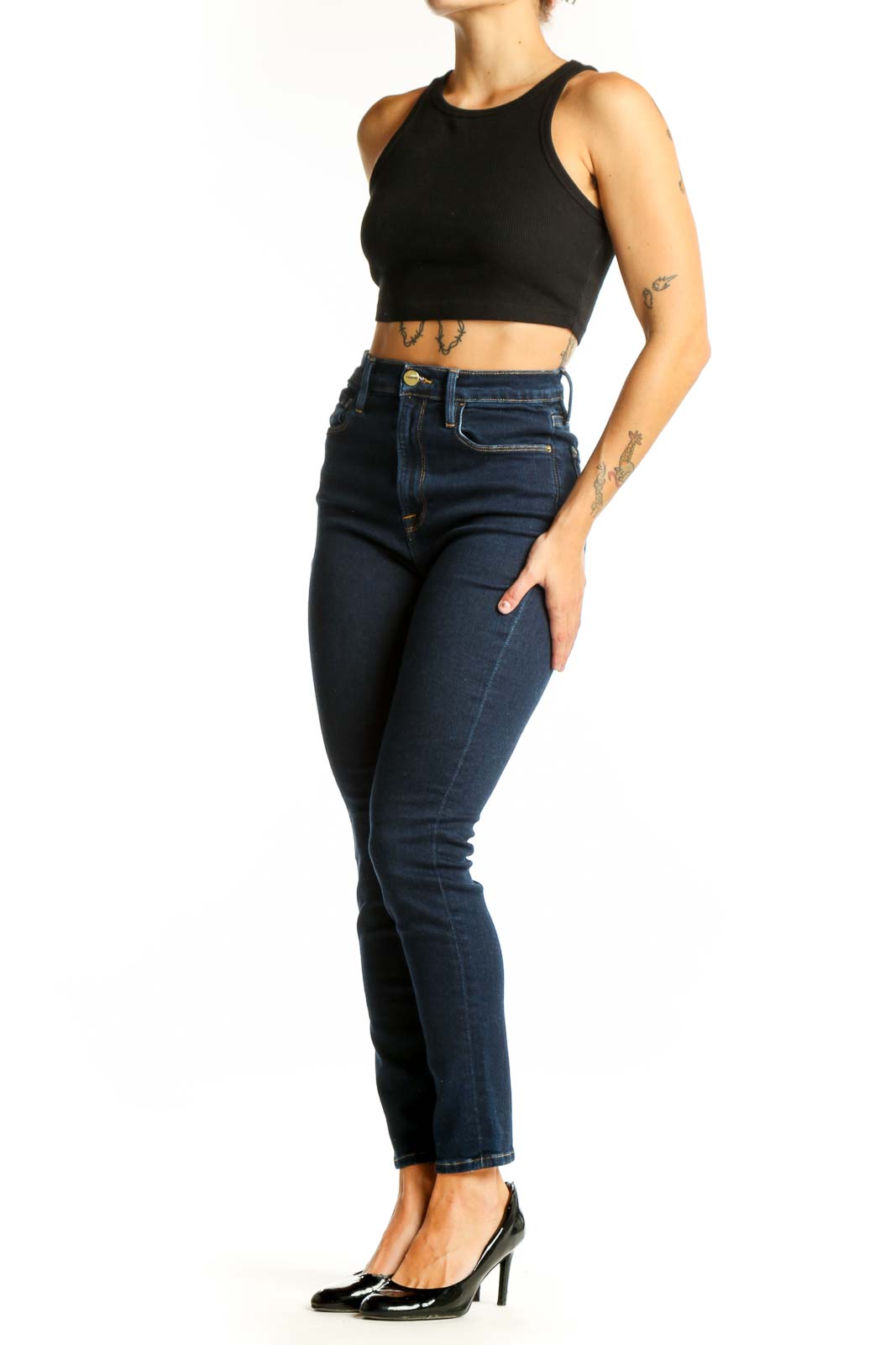 Front view of FRAME dark blue high-waisted skinny jeans on model