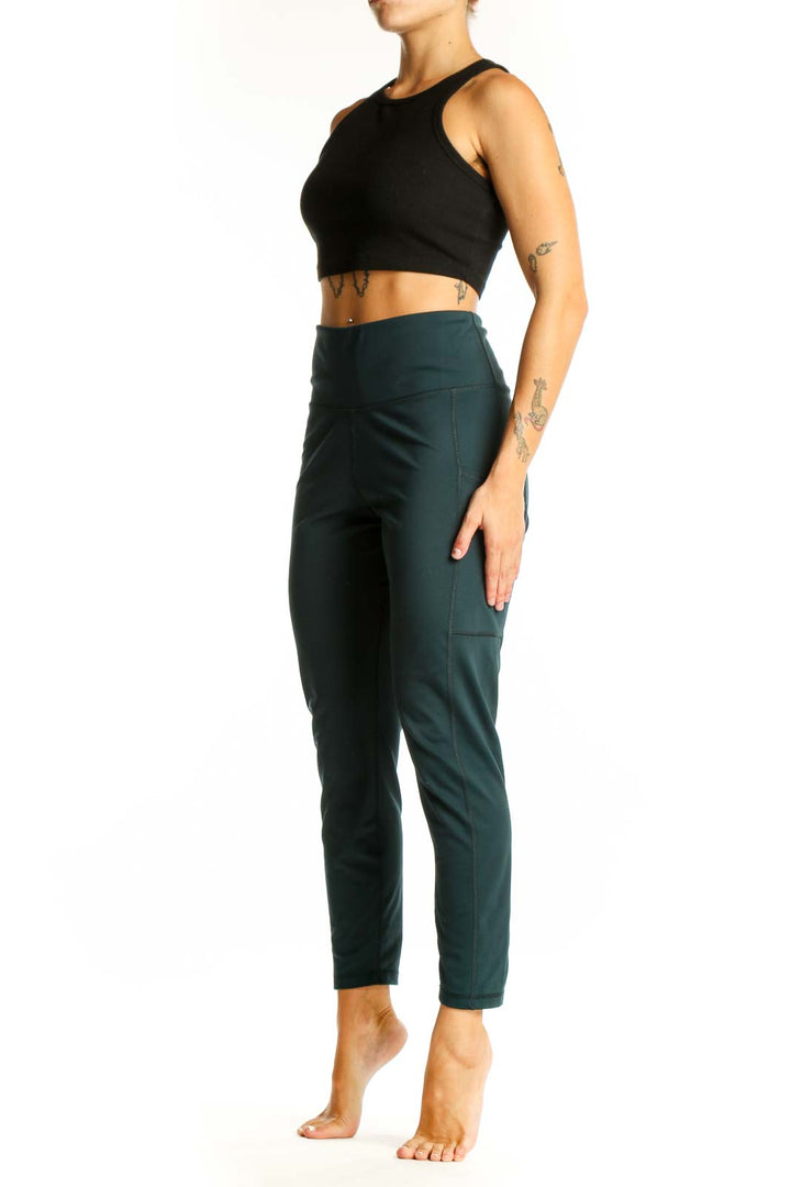 Front view of dark green high-waisted activewear leggings from Banana Republic
