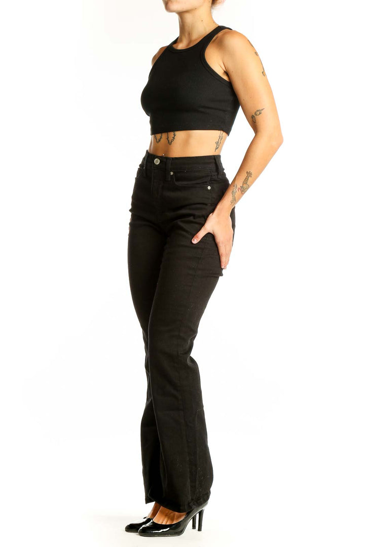 Front view of Banana Republic black high-waisted flared jeans on model