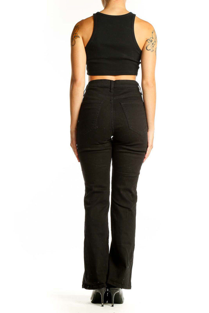 Side view of Banana Republic black high-waisted flared jeans on model