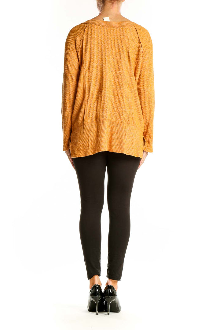 Side view of orange textured knit sweater by Eri + Ali on model