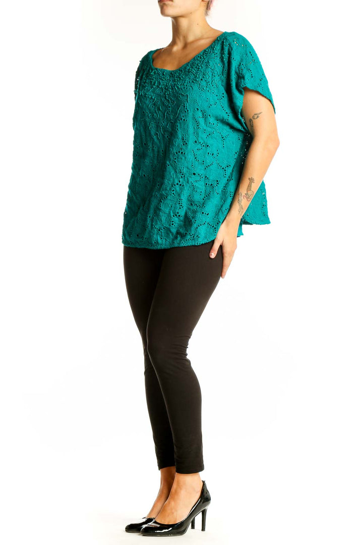 Front view of teal eyelet lace top with scoop neck and flutter sleeves