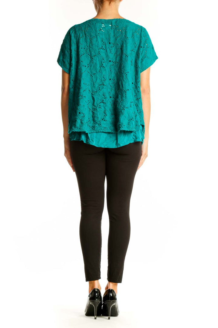 Side view of teal eyelet lace top showing flutter sleeve detail