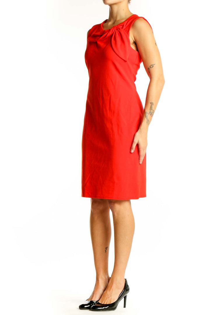 Front view of red sleeveless Banana Republic sheath dress with bow detail
