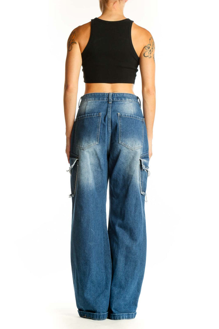 Side view of model wearing Love + Harmony blue distressed wide-leg cargo jeans