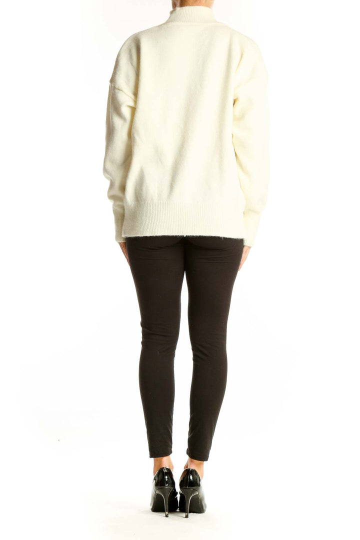 Side view of cream SilkRoll mock neck sweater showing relaxed fit