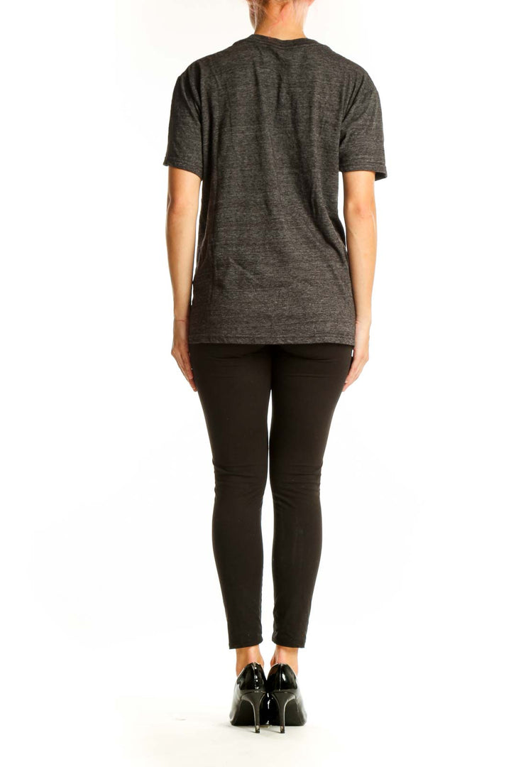 Side view of person wearing gray Guns N' Roses t-shirt with black pants