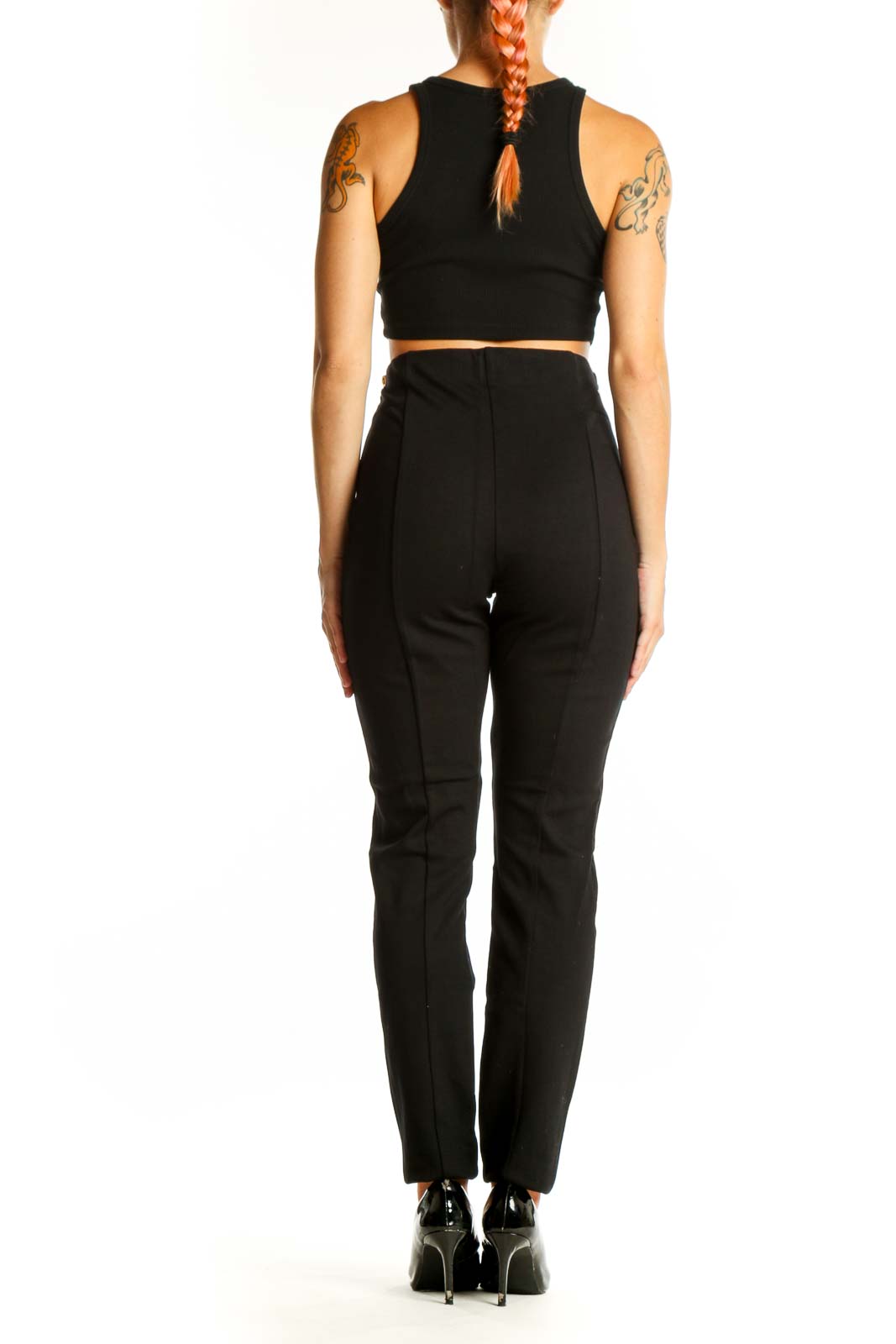 Side view of woman wearing I.N.C black high-waisted slim fit pants with crop top