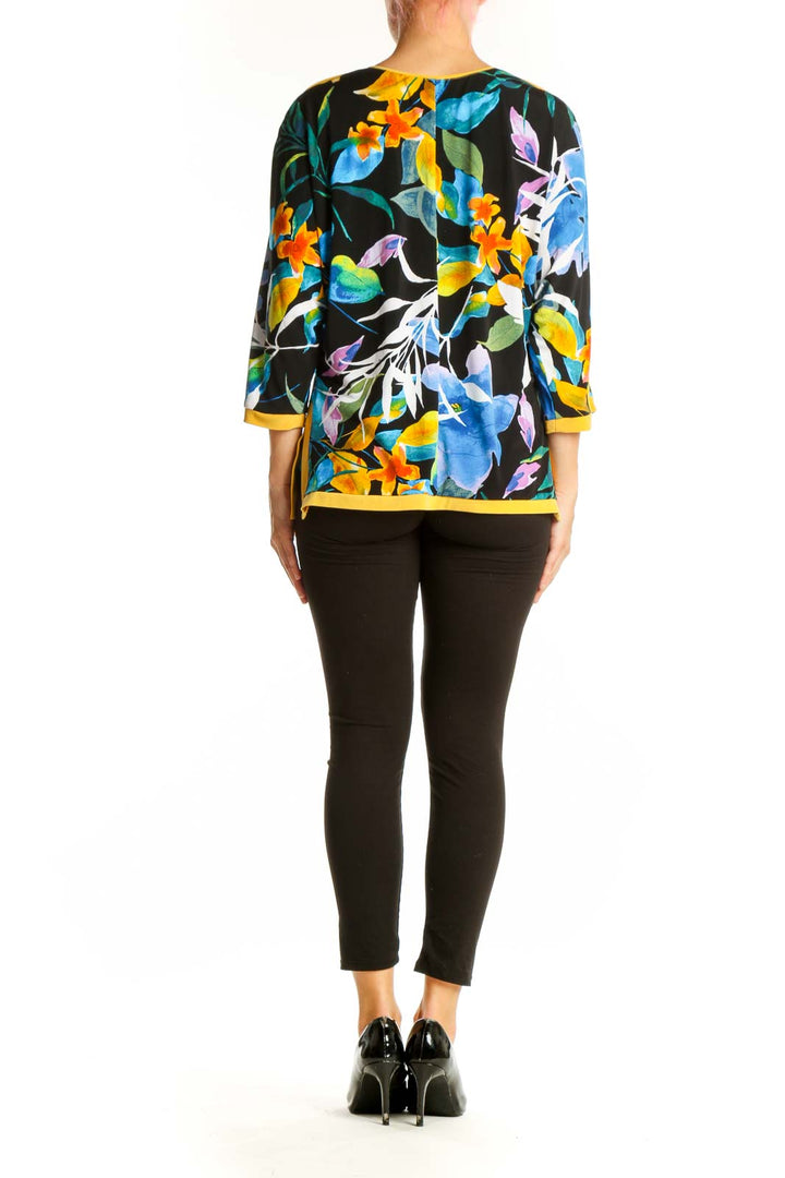 Side view of FRANK LYMAN multicolor floral V-neck blouse on model with black pants