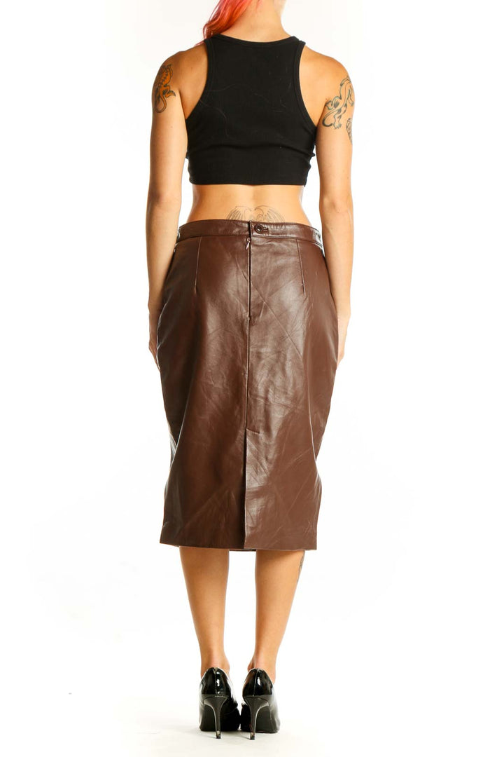 Side view of brown leather pencil skirt by SilkRoll with black crop top