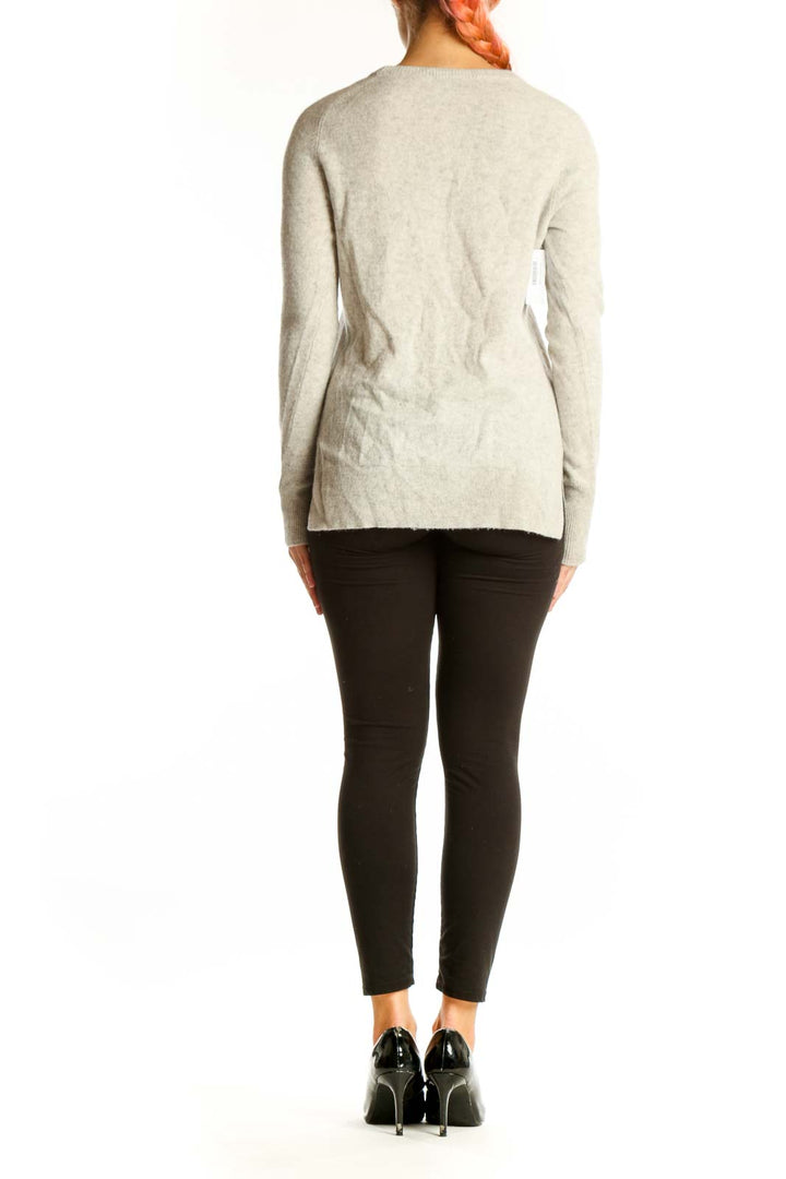 Side view of Halogen beige cashmere crewneck sweater on model with black pants