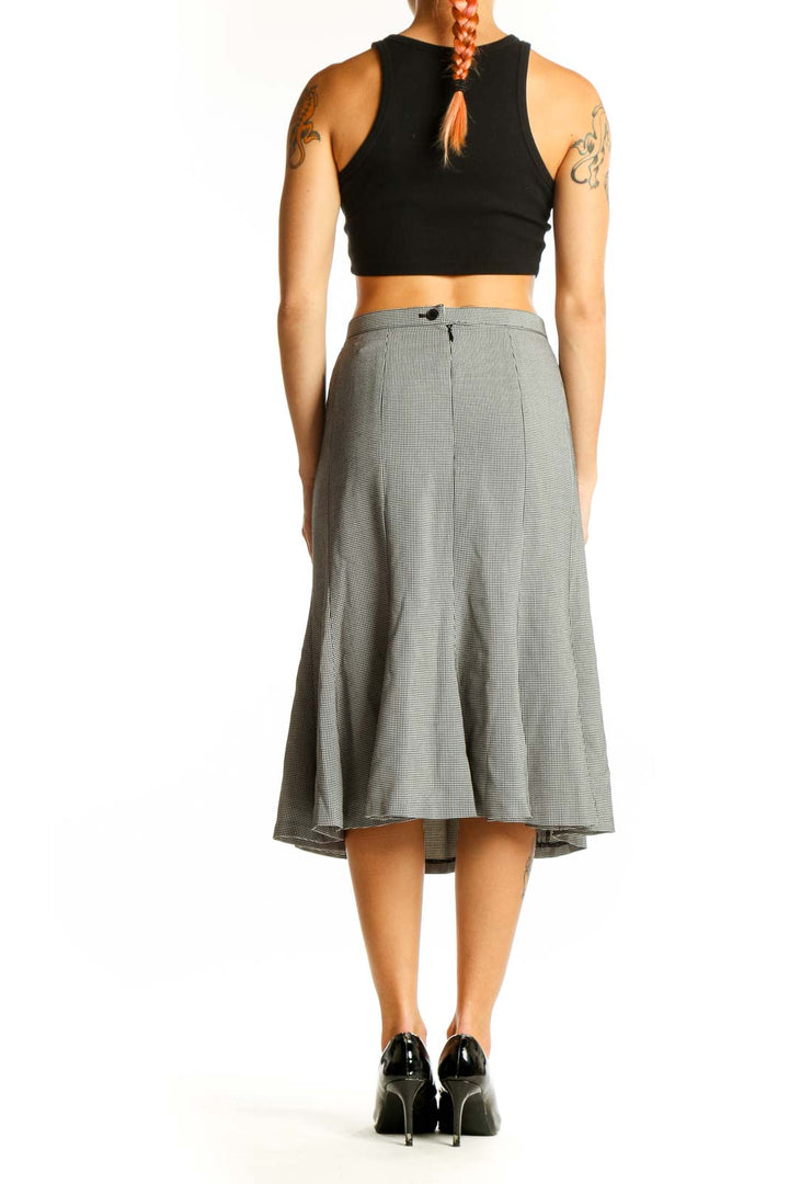 Side view of FOCUS 2000 gray houndstooth A-line midi skirt with black crop top