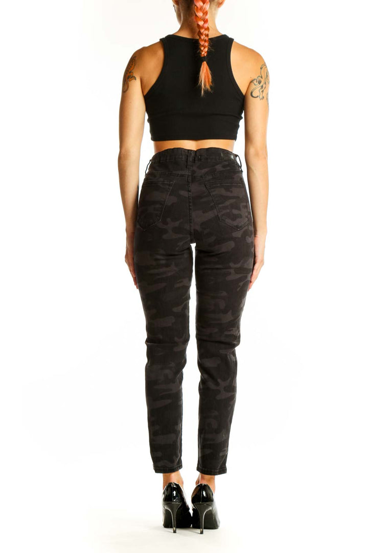 Side view of model wearing black camo print high-waisted jeans from Social Standard by Sanctuary