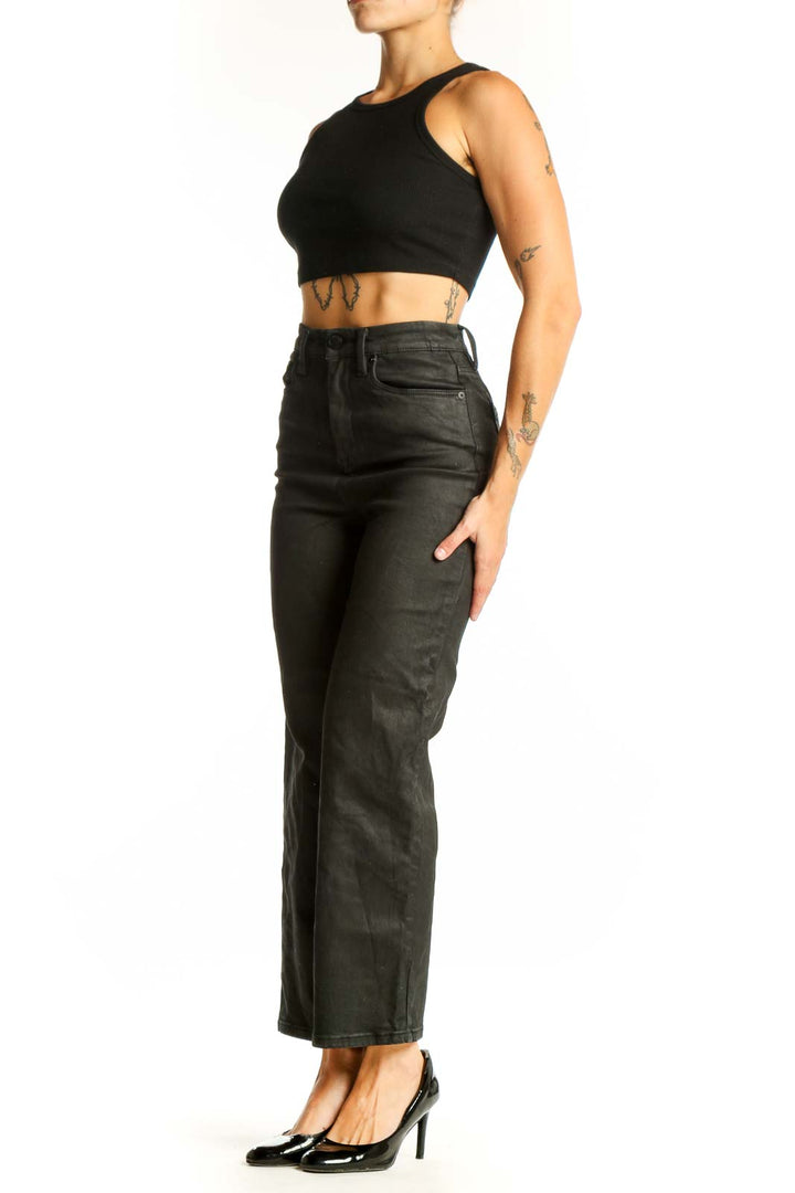 Front view of BLANKNYC black high-waisted wide-leg jeans on model