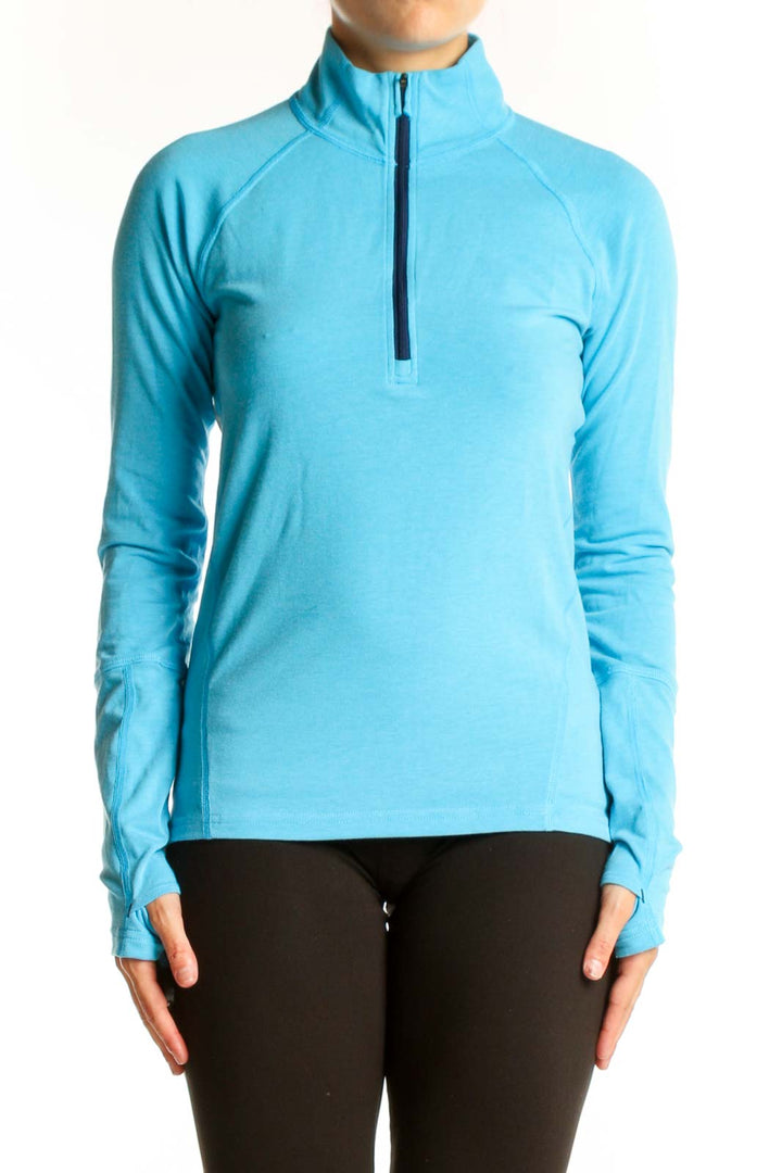Front view of Stio turquoise half-zip athletic top