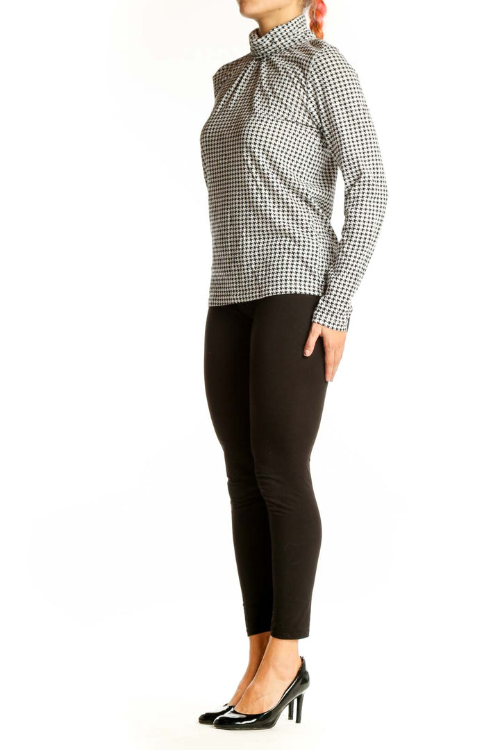 Front view of J.Crew black and white houndstooth turtleneck top