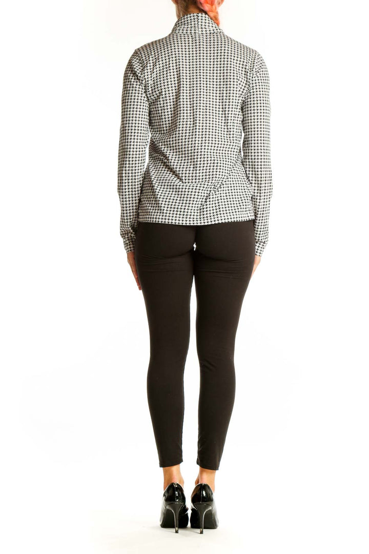 Side view of J.Crew black and white houndstooth turtleneck top on model