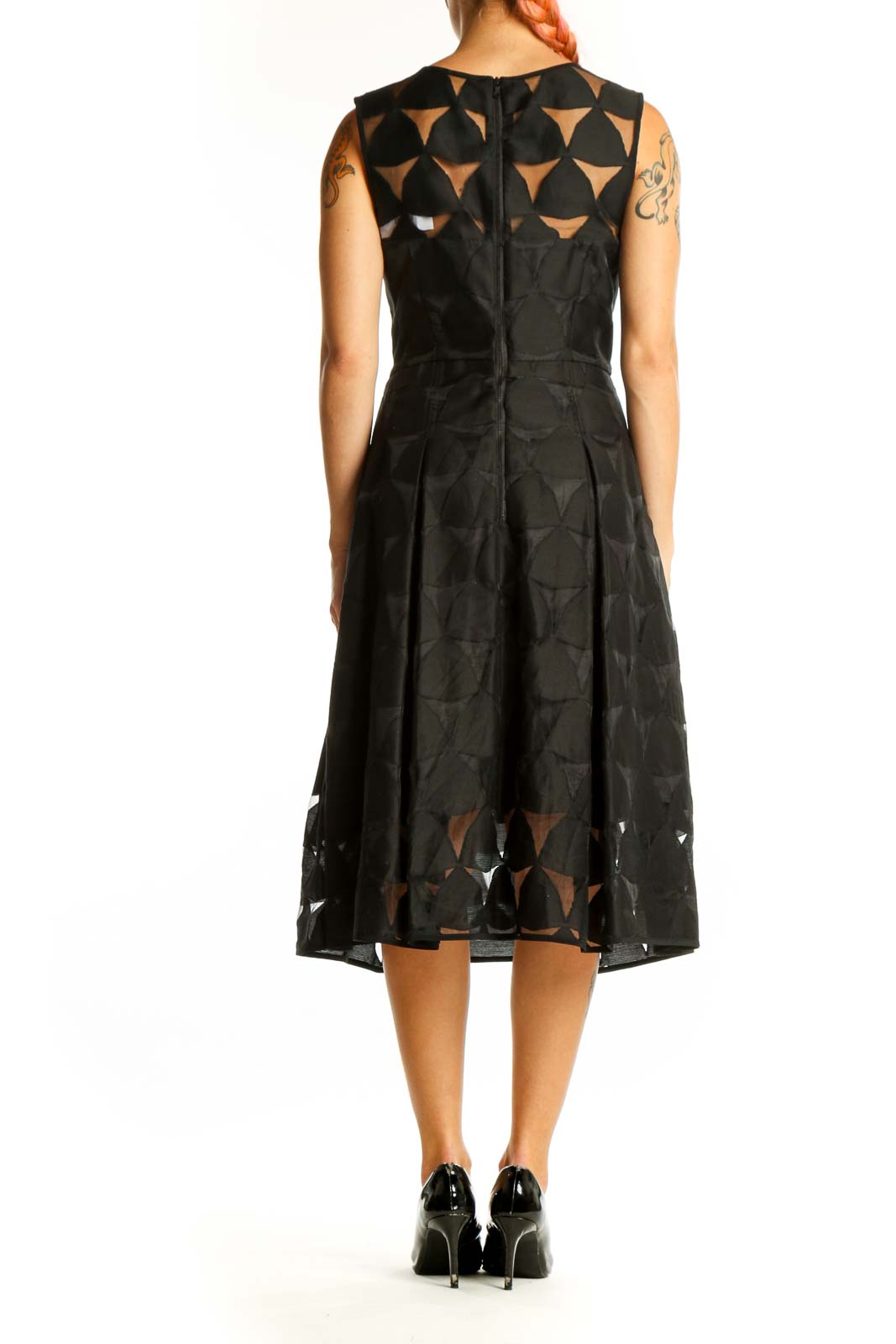 Back view of black Milly midi dress showing geometric cut-out details