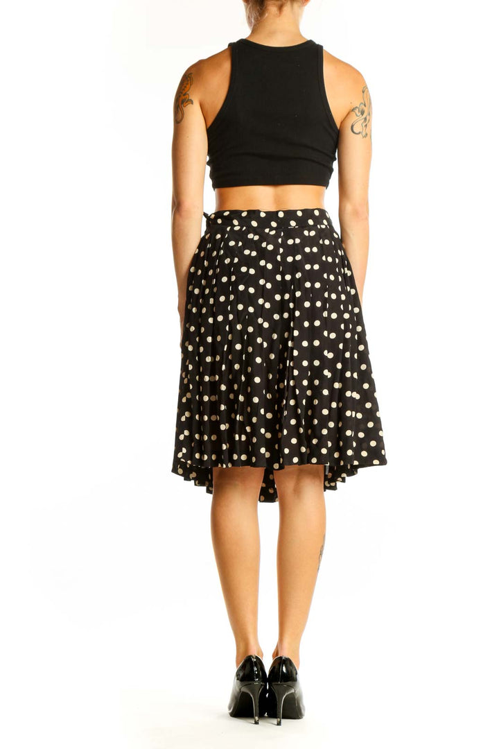 Side view of Laura Ashley black and white polka dot A-line skirt with black crop top