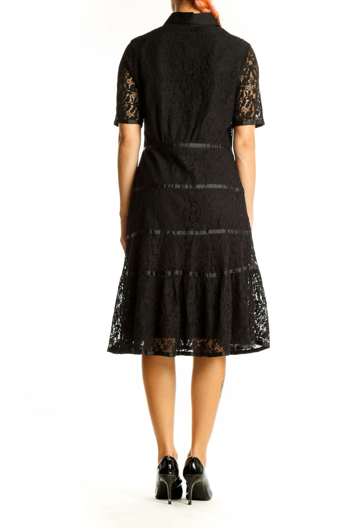 Side view of Nanette Lepore black lace shirt dress showing tiered skirt detail