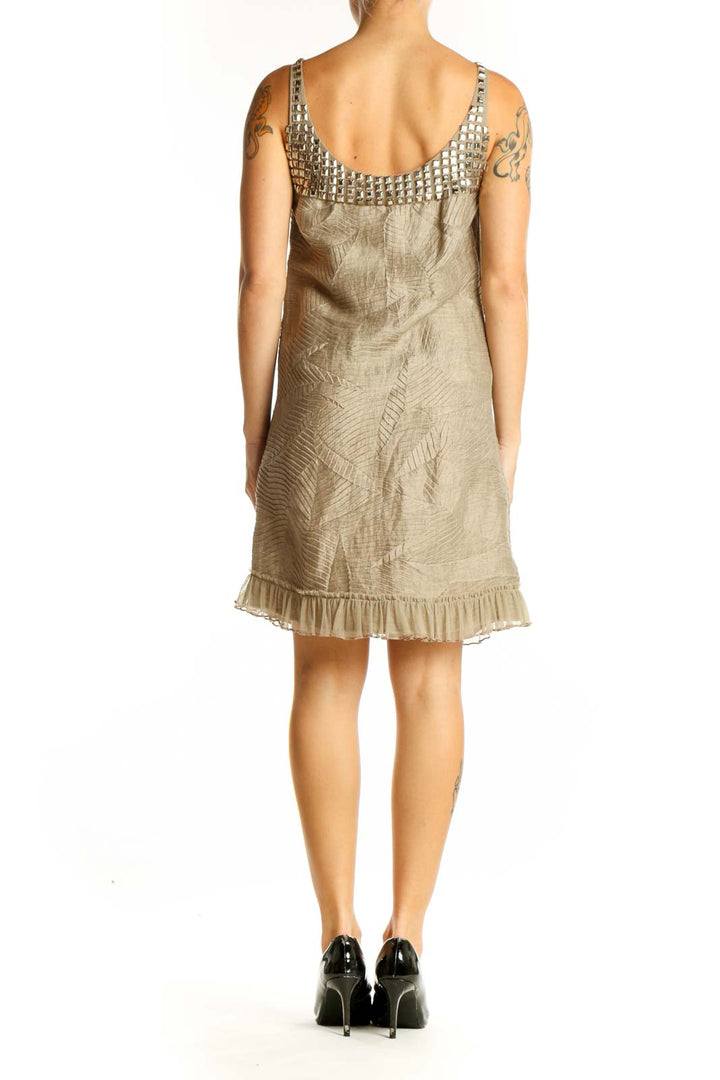Side view of Alice + Olivia beige linen blend dress showing leaf embroidery and ruffle hem
