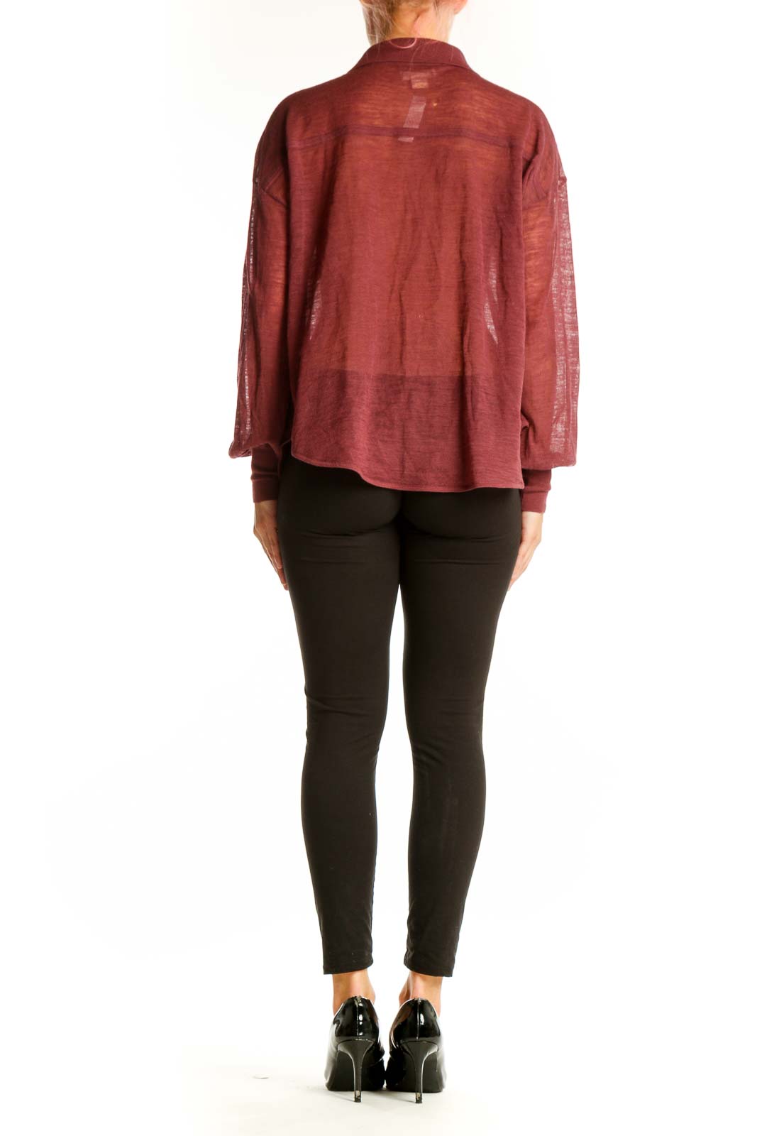 Side view of model wearing Maeve burgundy sheer blouse with black pants