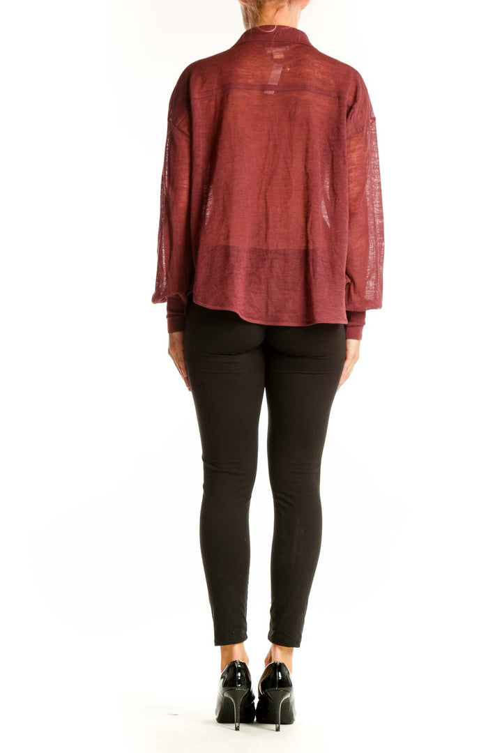 Side view of model wearing Maeve burgundy sheer blouse with black pants