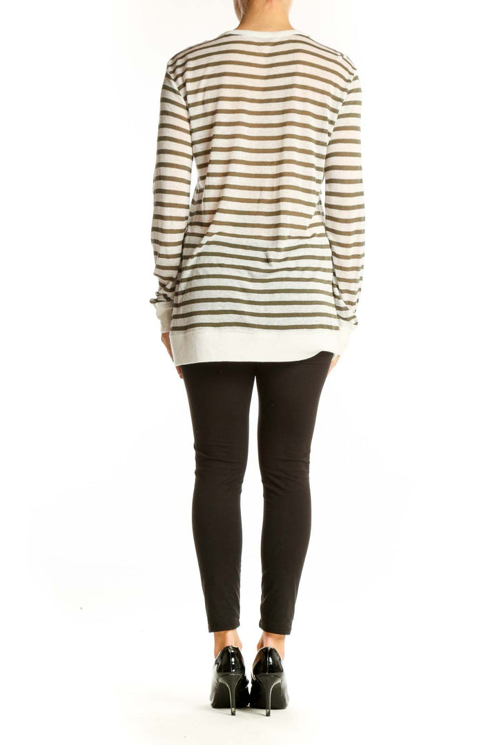 Side view of model wearing Alexander Wang beige striped long sleeve top with black pants
