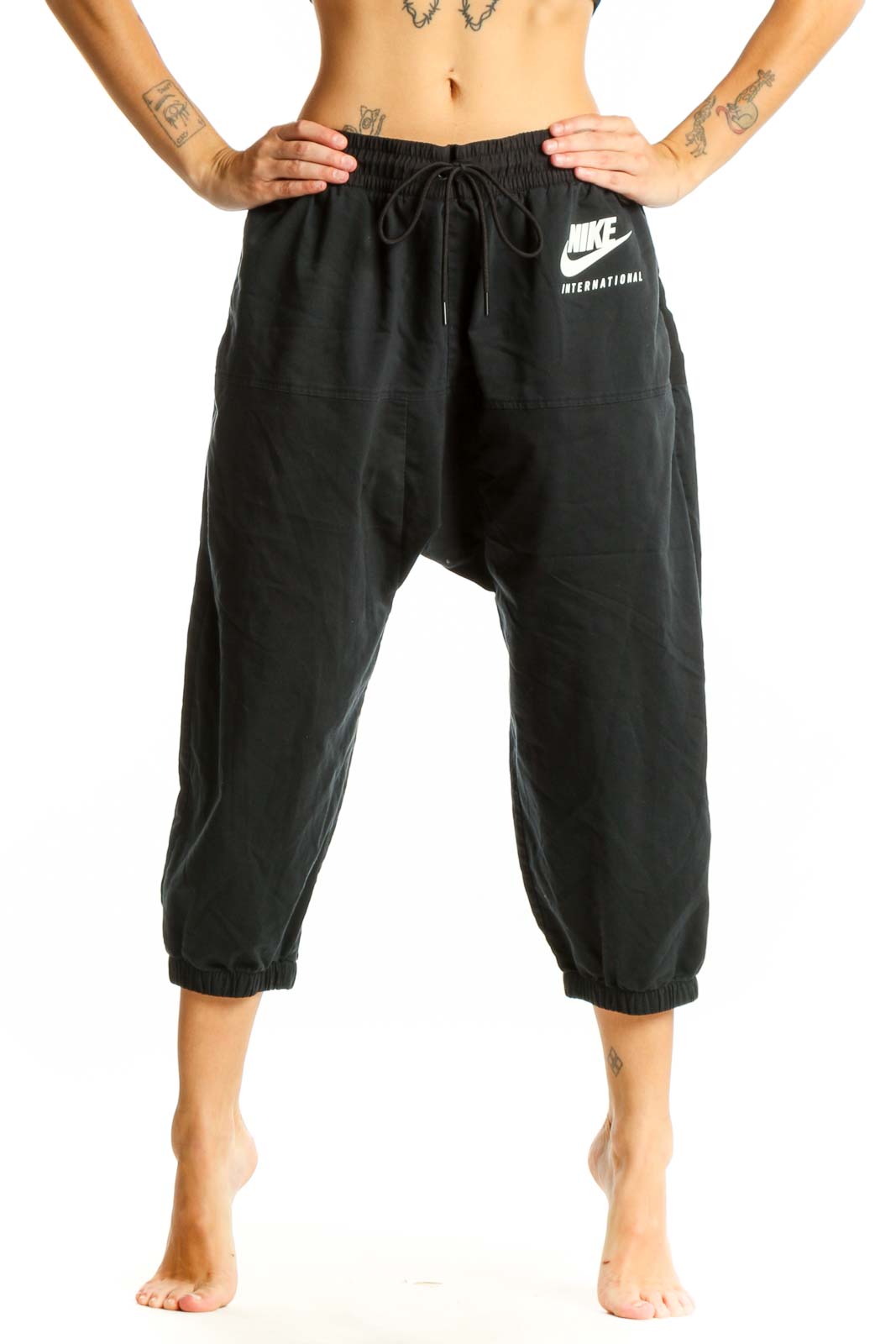 Front view of black Nike cropped jogger pants with drawstring waist