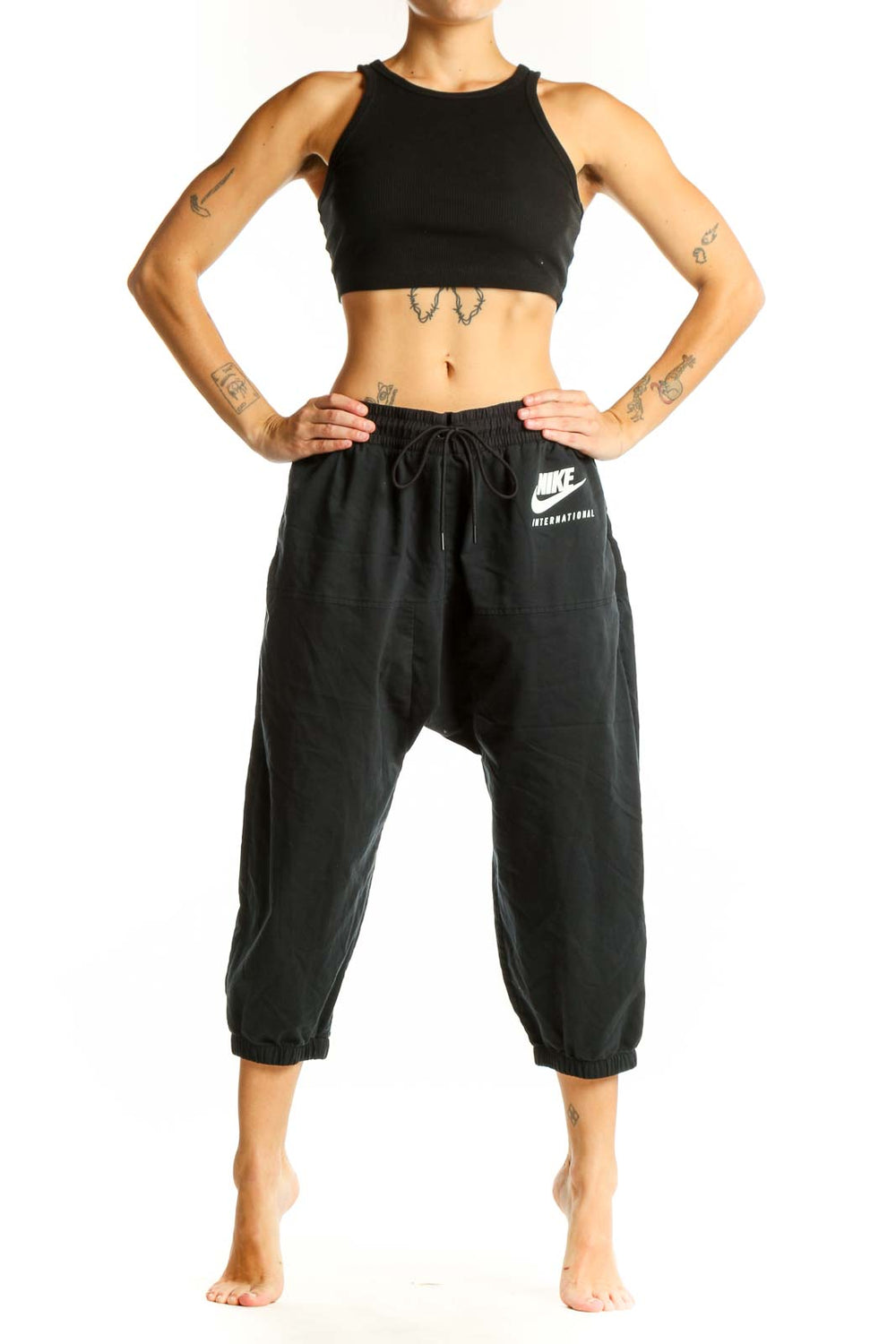 Front view of black Nike cropped jogger pants with drawstring waist