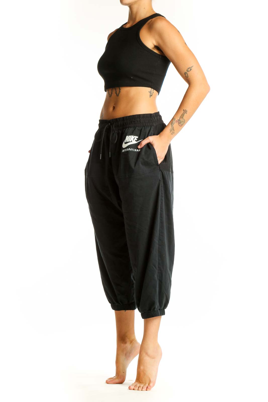 Front view of black Nike cropped jogger pants with drawstring waist