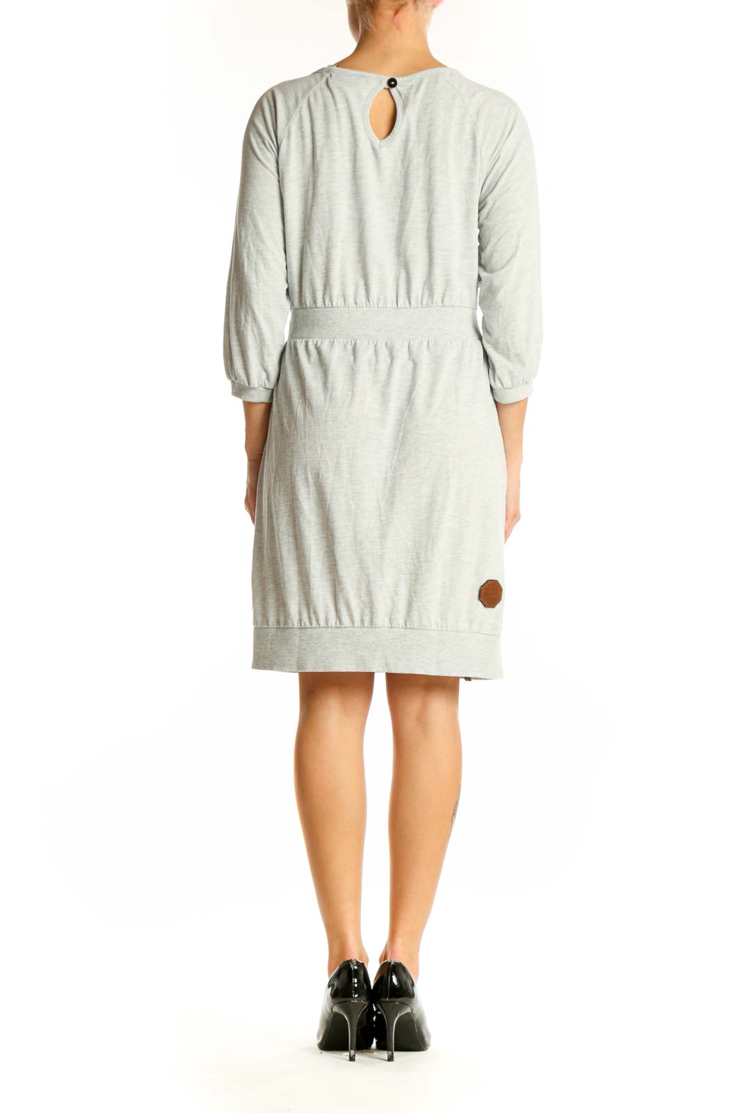 Back view of light gray Naketano casual dress showing gathered waistline and knee-length cut