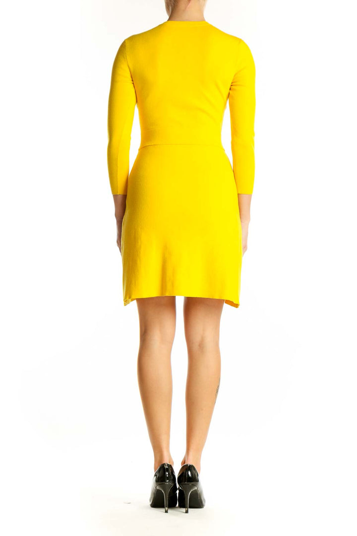 Side view of yellow long-sleeve ALC mini dress showing side slit