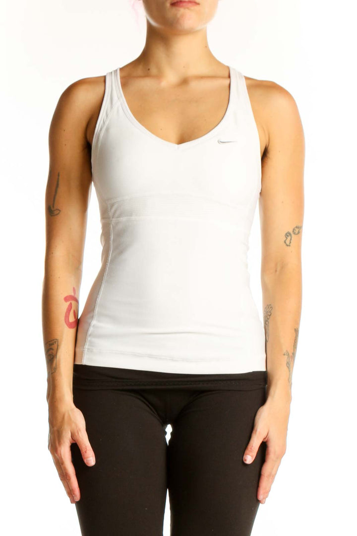 Front view of white Nike racerback tank top on model