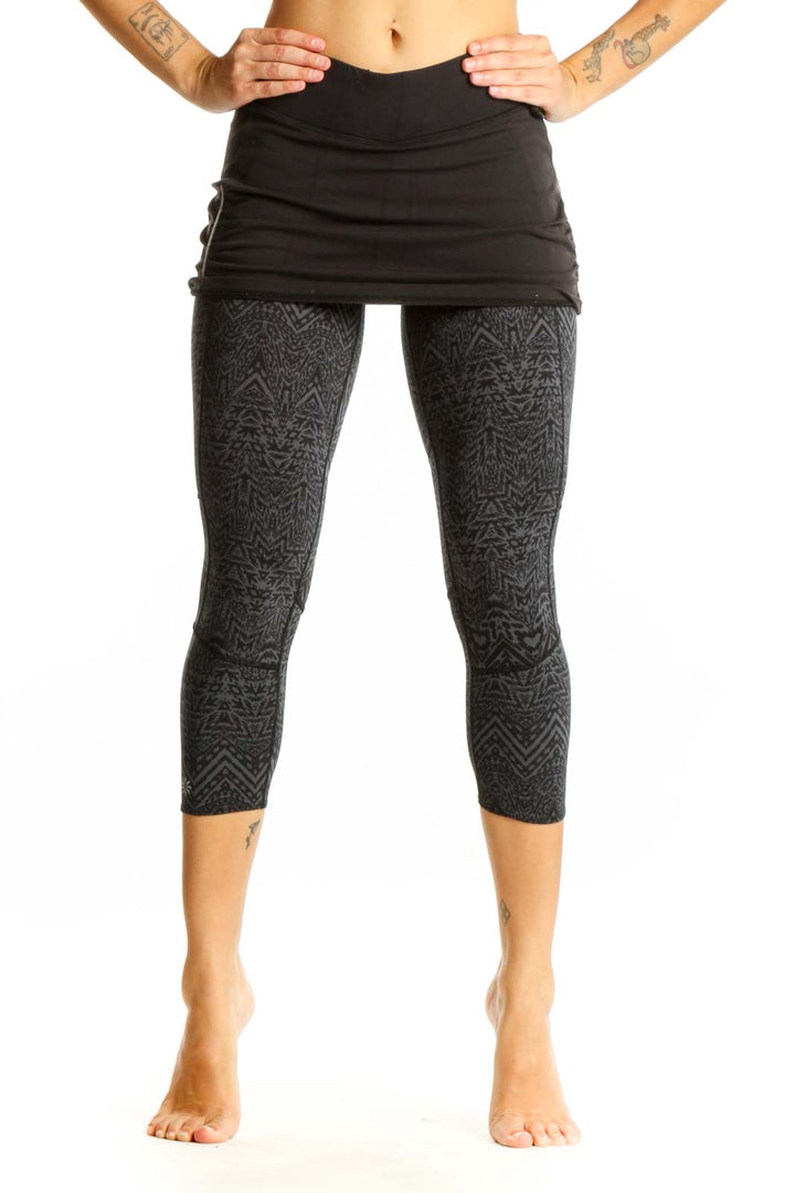 Front view of Athleta black patterned capri leggings with attached skirt