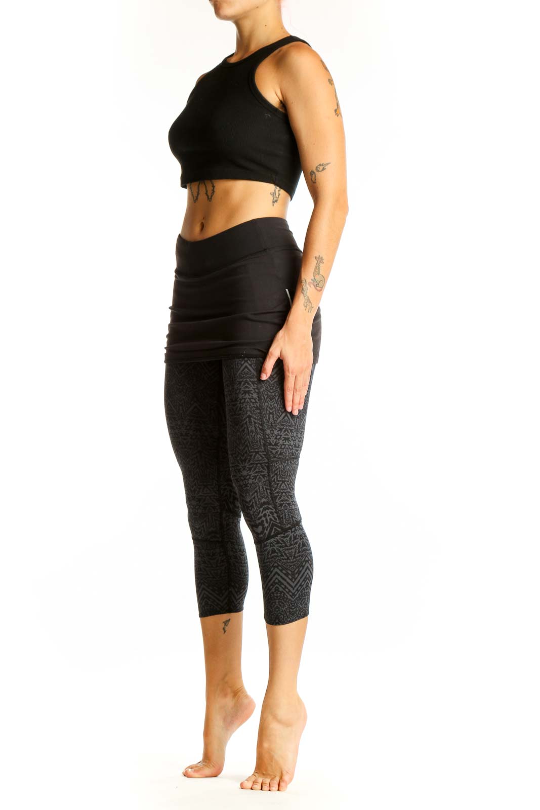 Front view of Athleta black patterned capri leggings with attached skirt