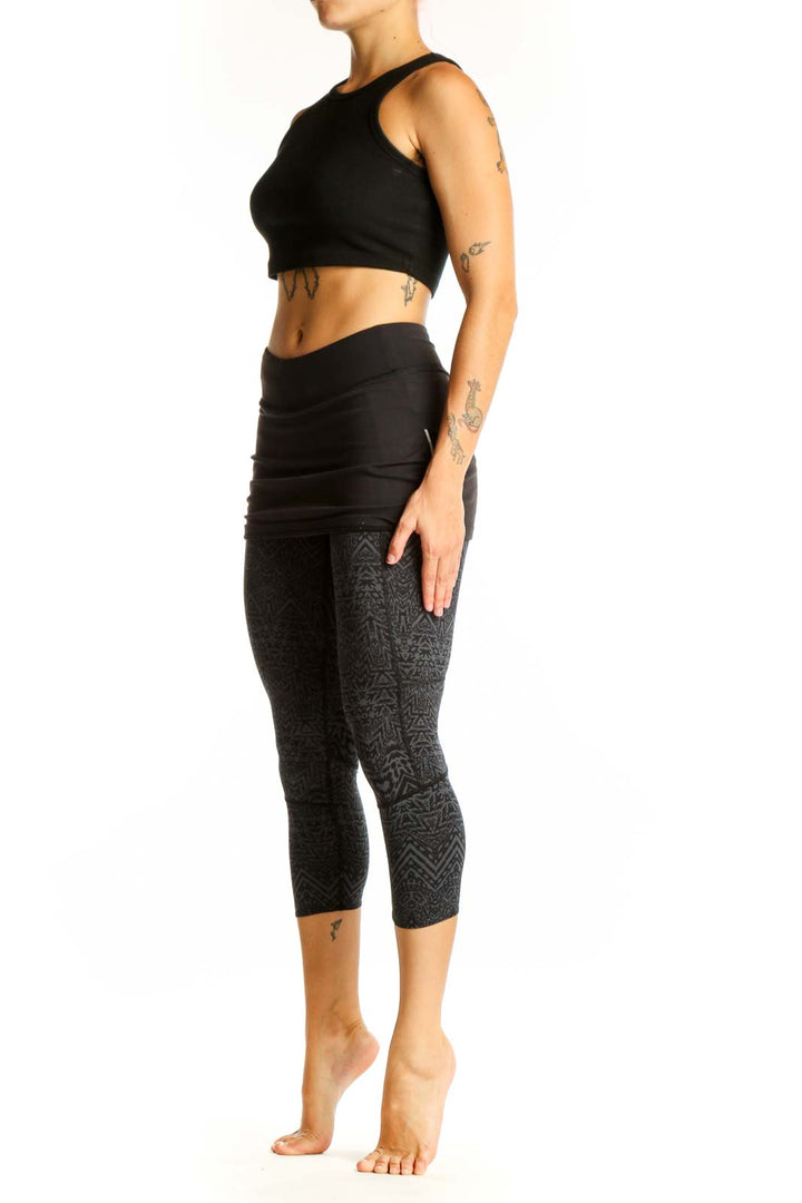 Front view of Athleta black patterned capri leggings with attached skirt