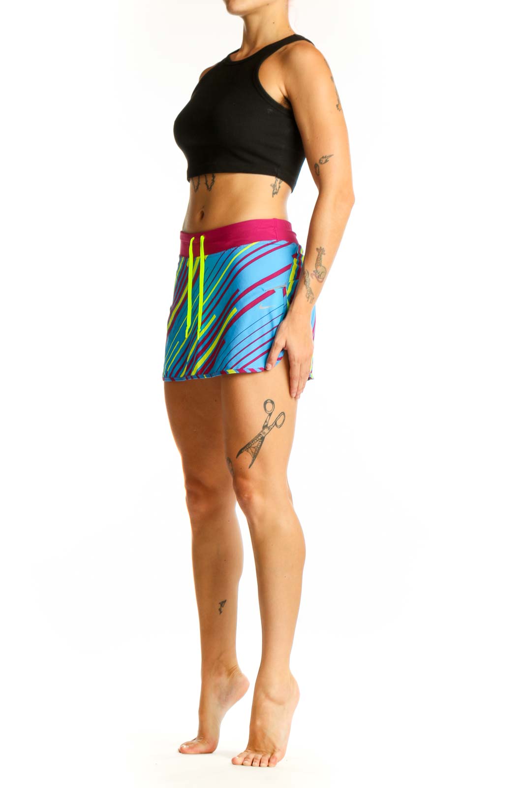 Front view of blue Nike athletic skort with pink and yellow stripes