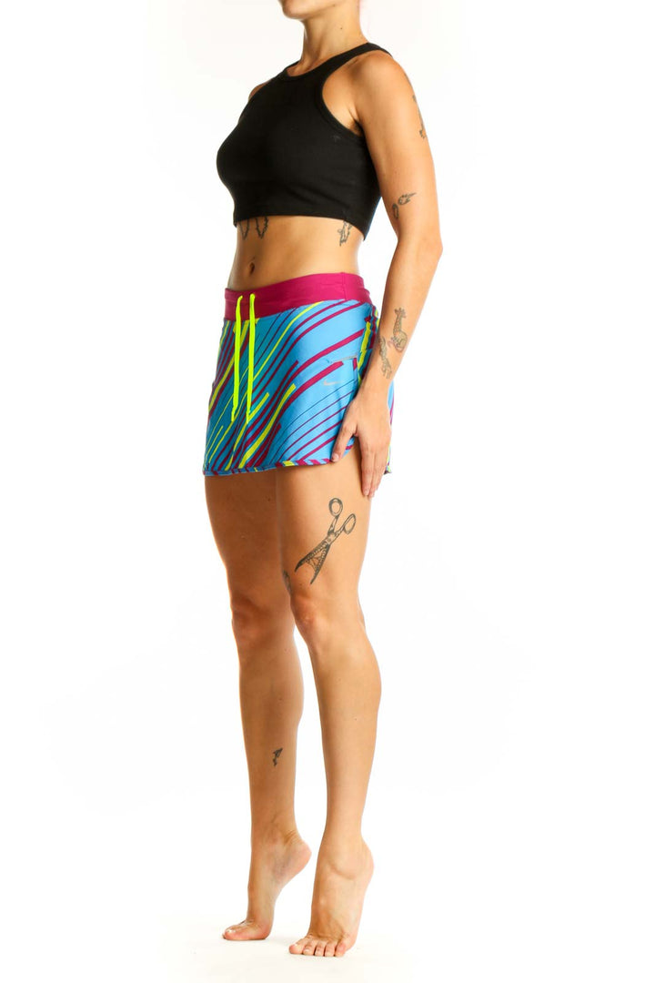 Front view of blue Nike athletic skort with pink and yellow stripes