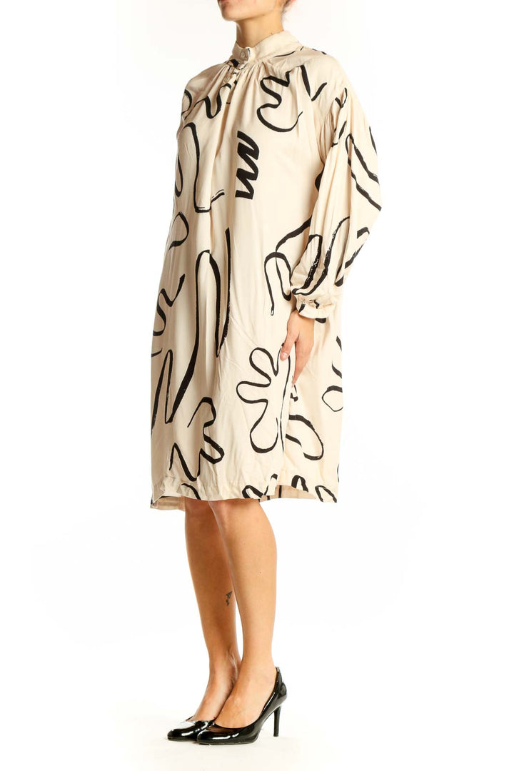 Front view of Eve Gravel beige viscose dress with black abstract pattern
