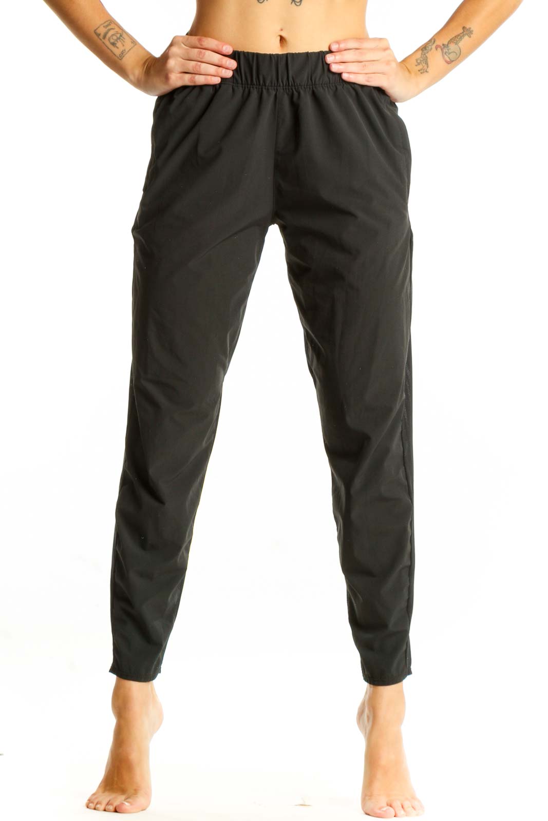 Front view of black Nike athletic performance pants with tapered leg