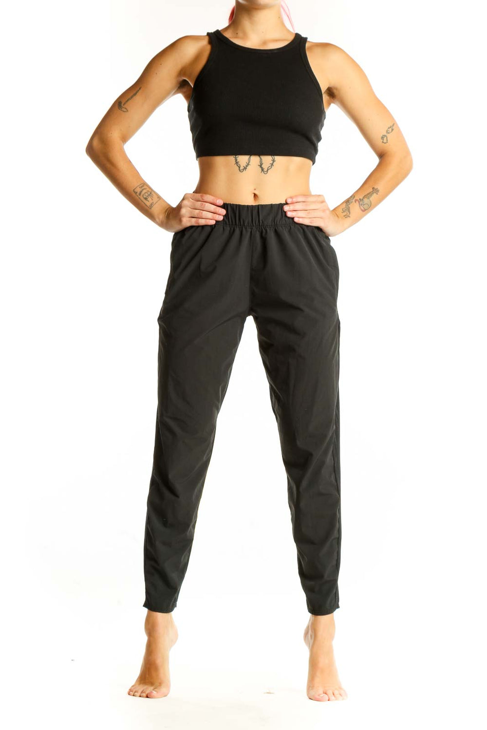 Front view of black Nike athletic performance pants with tapered leg