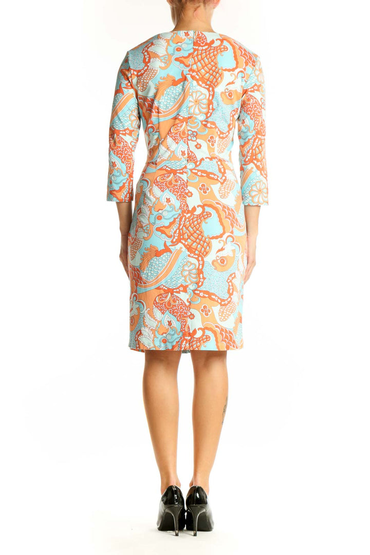 Side view of JMcLaughlin orange and blue floral print fitted dress