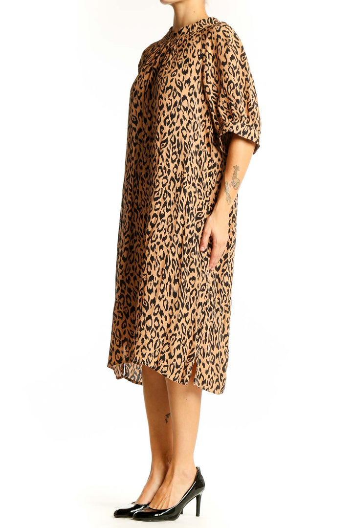 Front view of tan leopard print midi dress from Anthropologie
