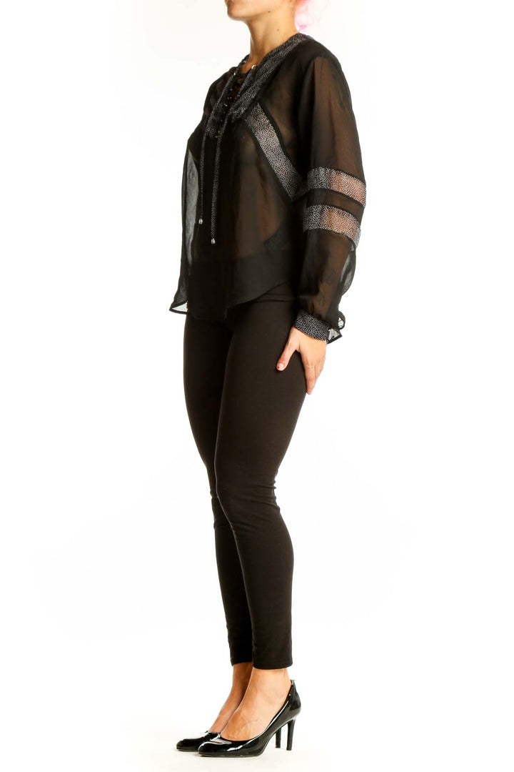 Front view of black sheer lace-up blouse by The Kooples