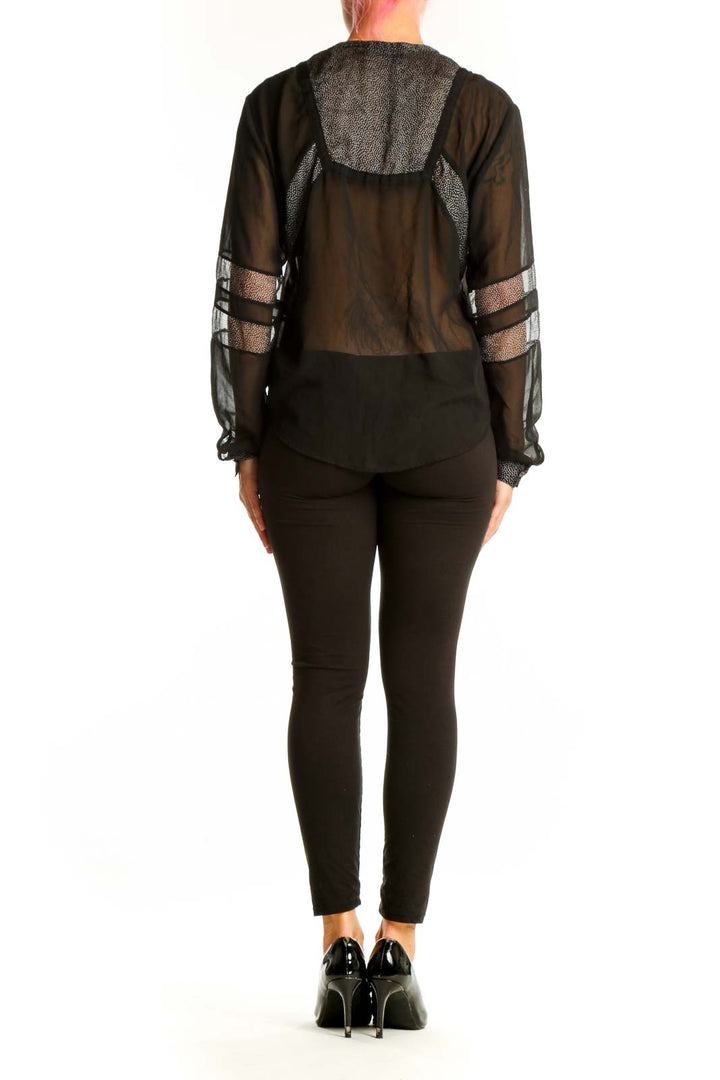 Side view of black sheer lace-up blouse by The Kooples on model